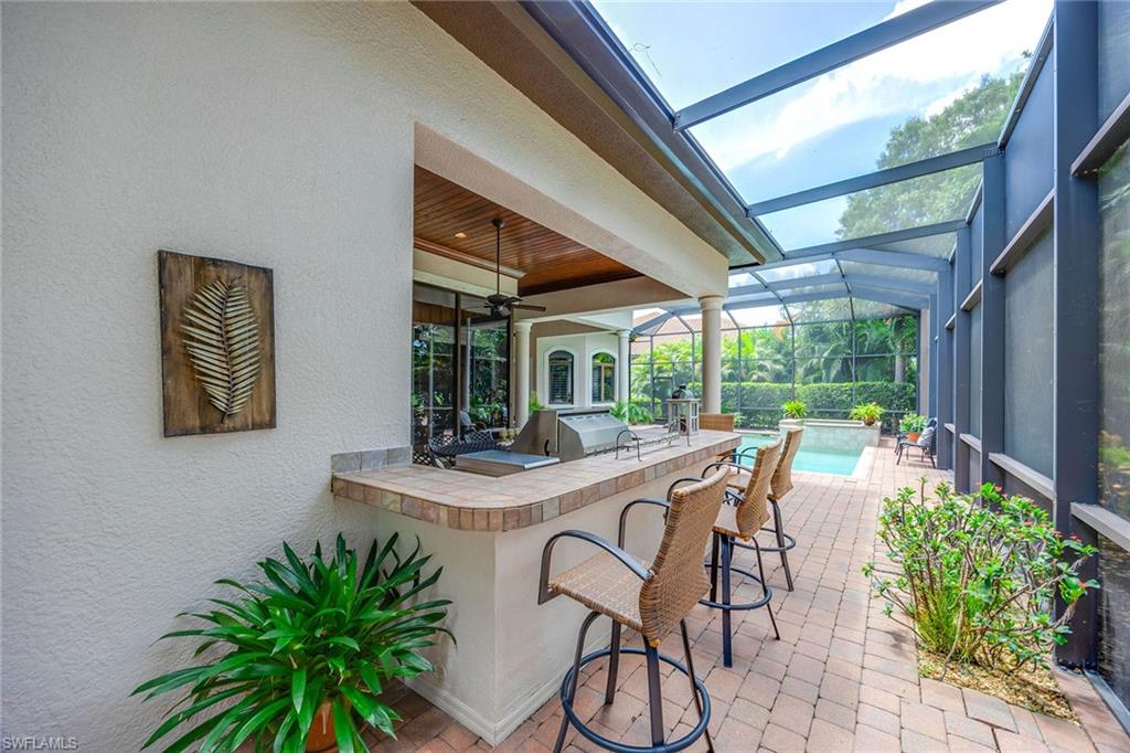 9038 Shenendoah Circle Naples, FL 34113 - Photo 43 of 50 a view of a patio with table and chairs and potted plants