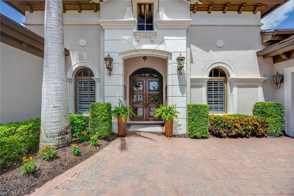 9038 Shenendoah Circle Naples, FL 34113 - Photo 5 of 50 a front view of a house with garden