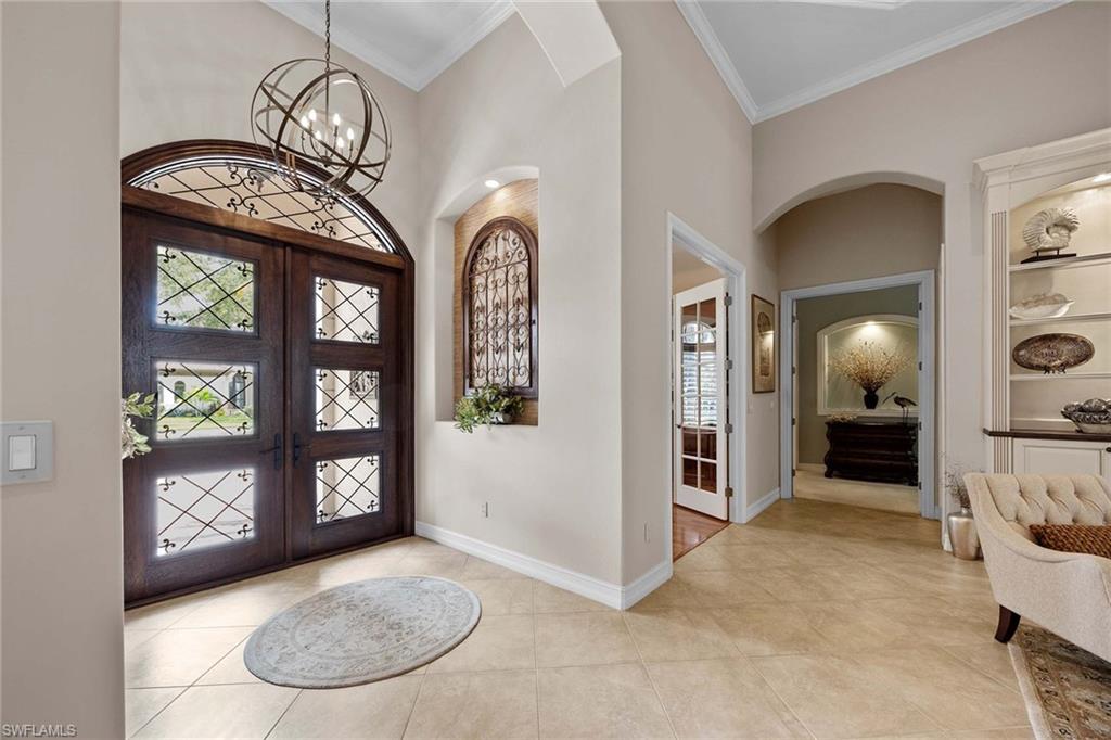 9038 Shenendoah Circle Naples, FL 34113 - Photo 6 of 50 an entryway with a livingroom and a chandelier