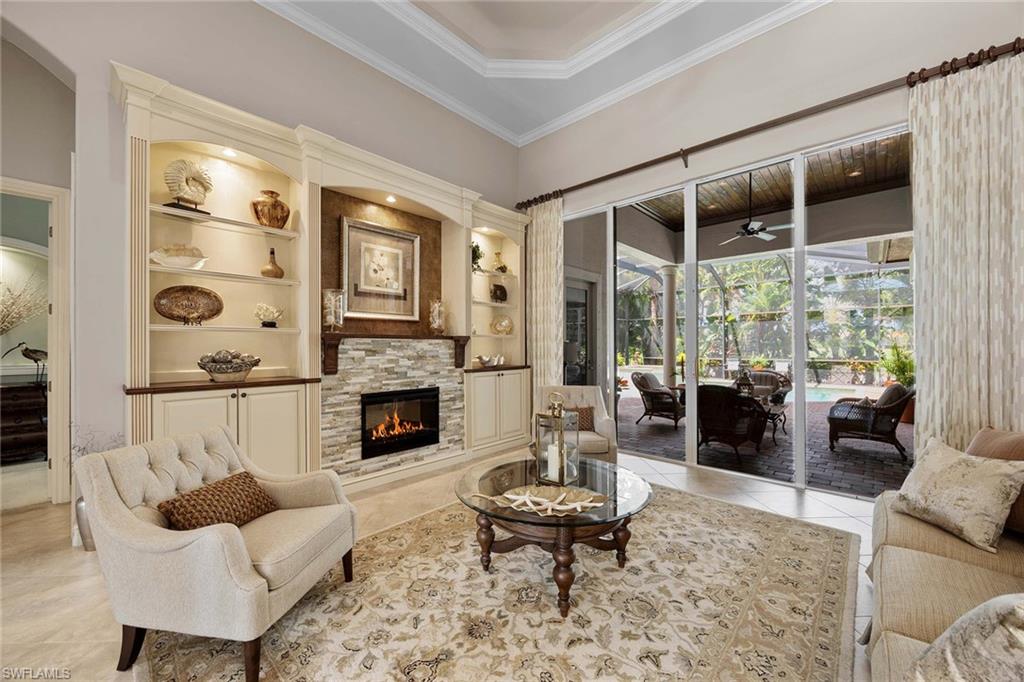 9038 Shenendoah Circle Naples, FL 34113 - Photo 7 of 50 a living room with furniture a fireplace and window