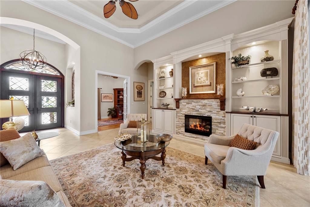 9038 Shenendoah Circle Naples, FL 34113 - Photo 8 of 50 a living room with furniture and a fireplace