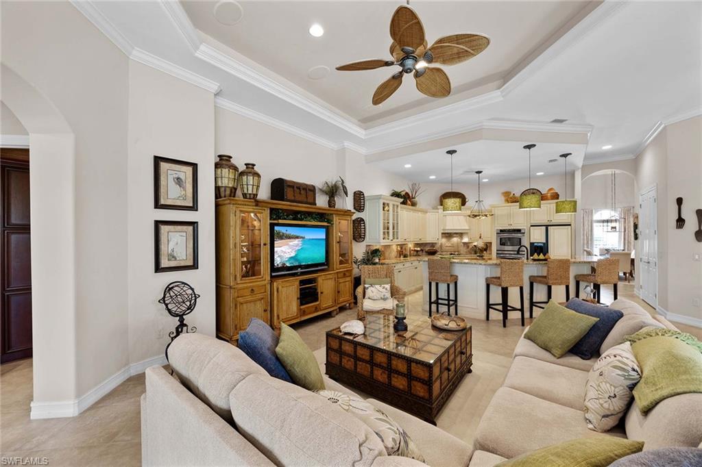 9038 Shenendoah Circle Naples, FL 34113 - Photo 10 of 50 a living room with furniture and a flat screen tv