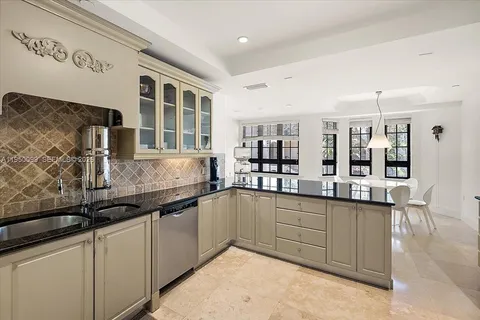 a bedroom with furniture and a large window