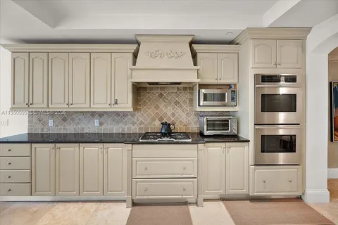 a living room with a black white checkered floor with couches chair and a coffee table