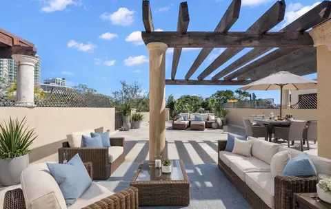 an aerial view of residential house with outdoor space and trees all around