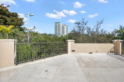 an aerial view of residential house with outdoor space and trees all around