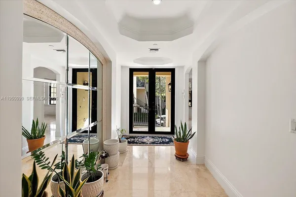 a dining room with wooden floor a chandelier a wooden table and chairs
