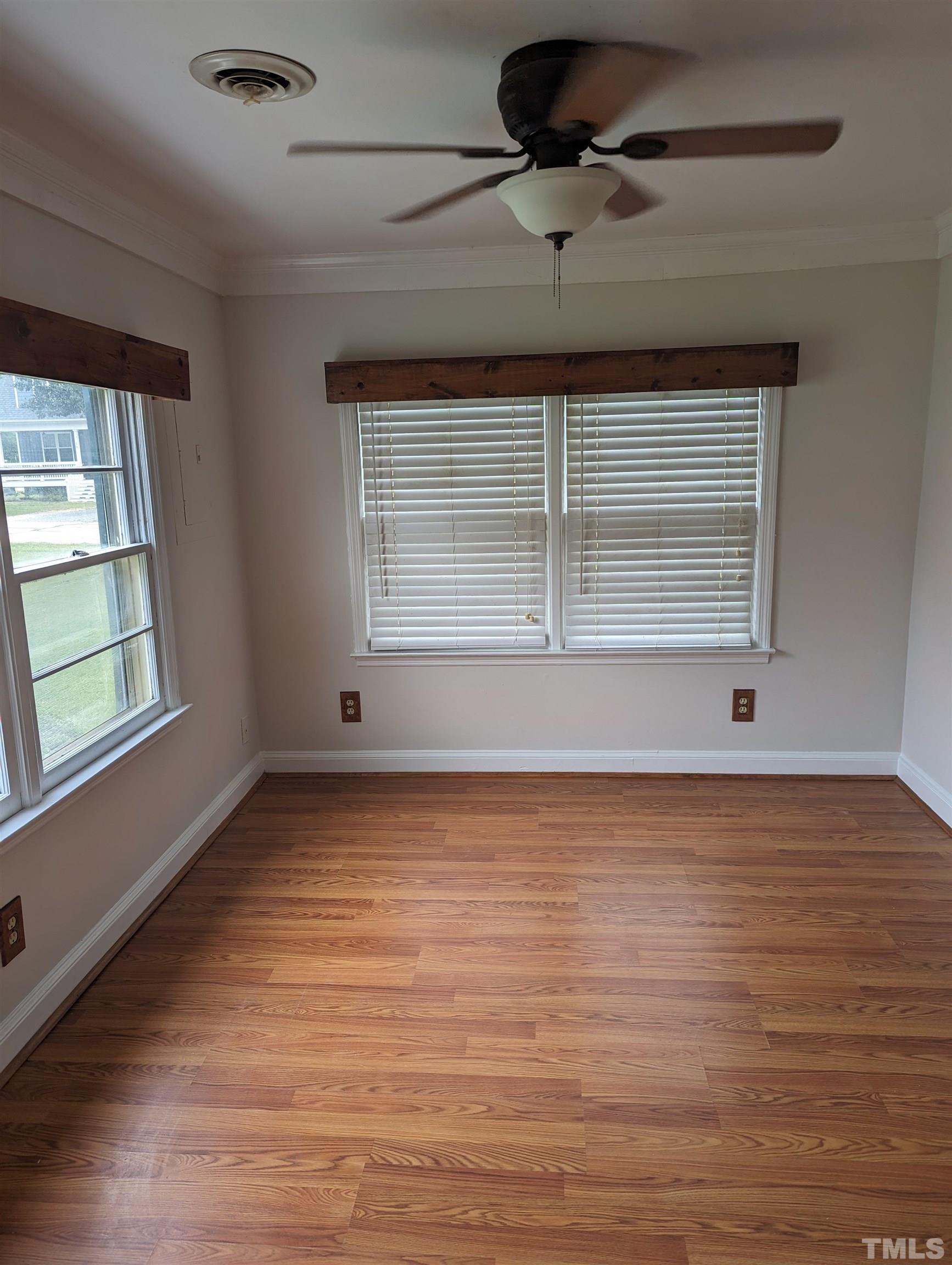 208 East Main Street Coats, NC 27521 - Photo 14 of 27 a view of an empty room with wooden floor and a window