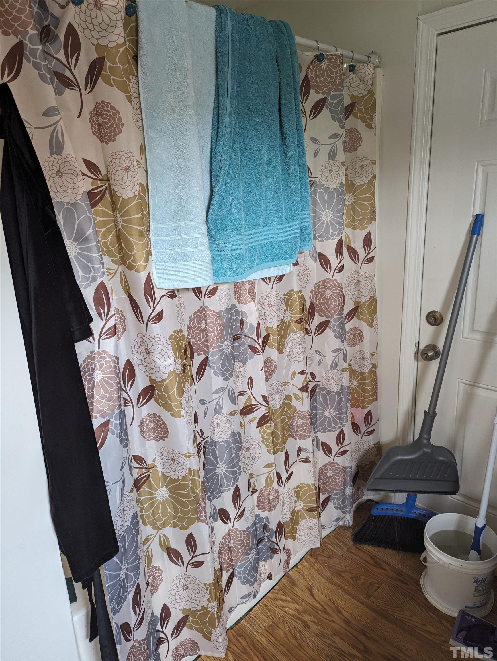 208 East Main Street Coats, NC 27521 - Photo 19 of 27 a bathroom with a toilet and a shower curtain