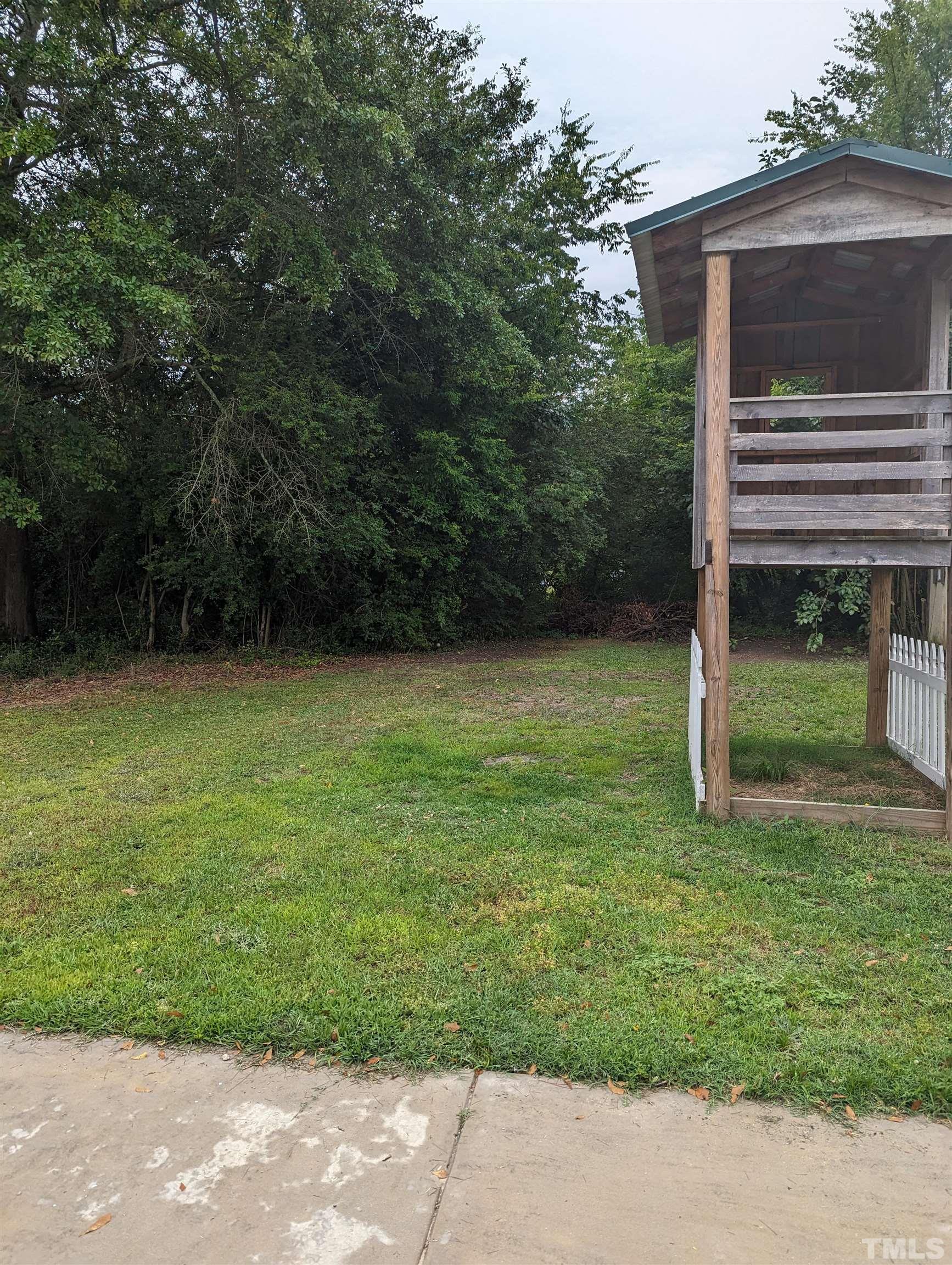 208 East Main Street Coats, NC 27521 - Photo 20 of 27 a view of a backyard with a garden