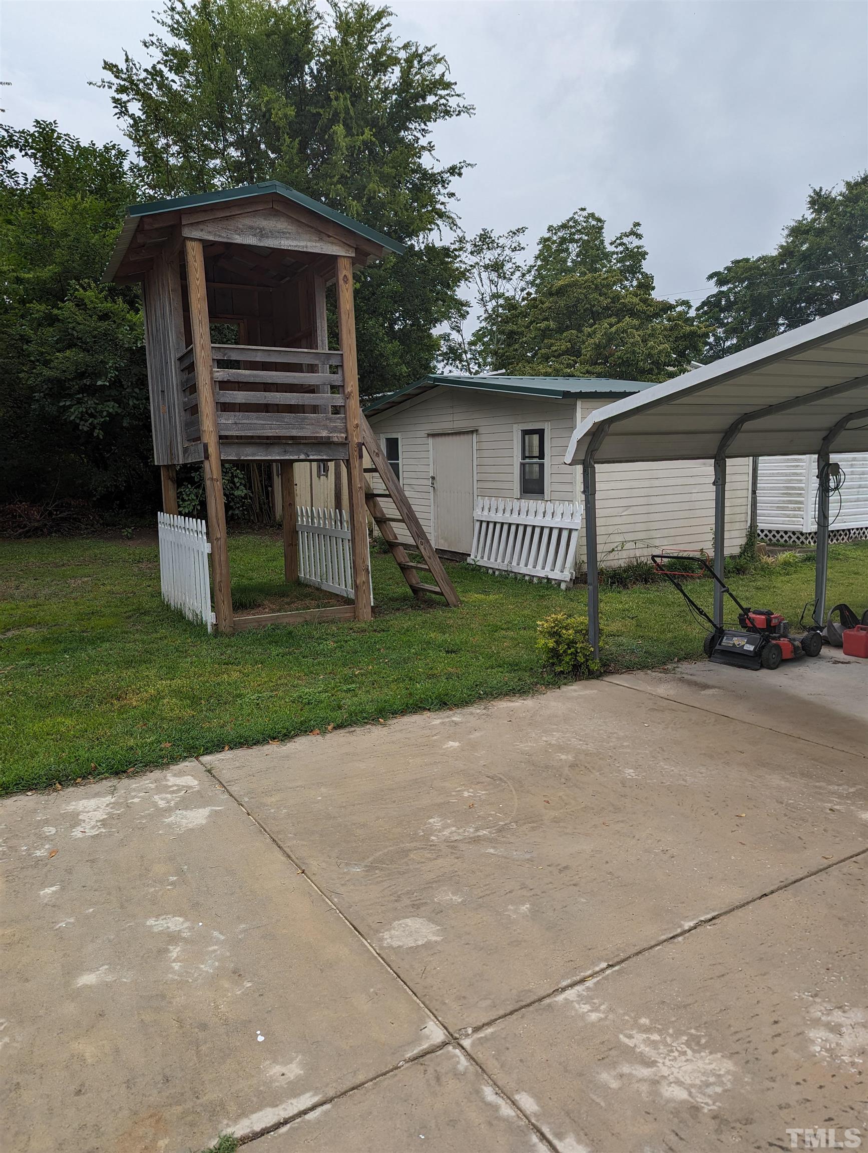 208 East Main Street Coats, NC 27521 - Photo 22 of 27 a front view of house with yard and green space