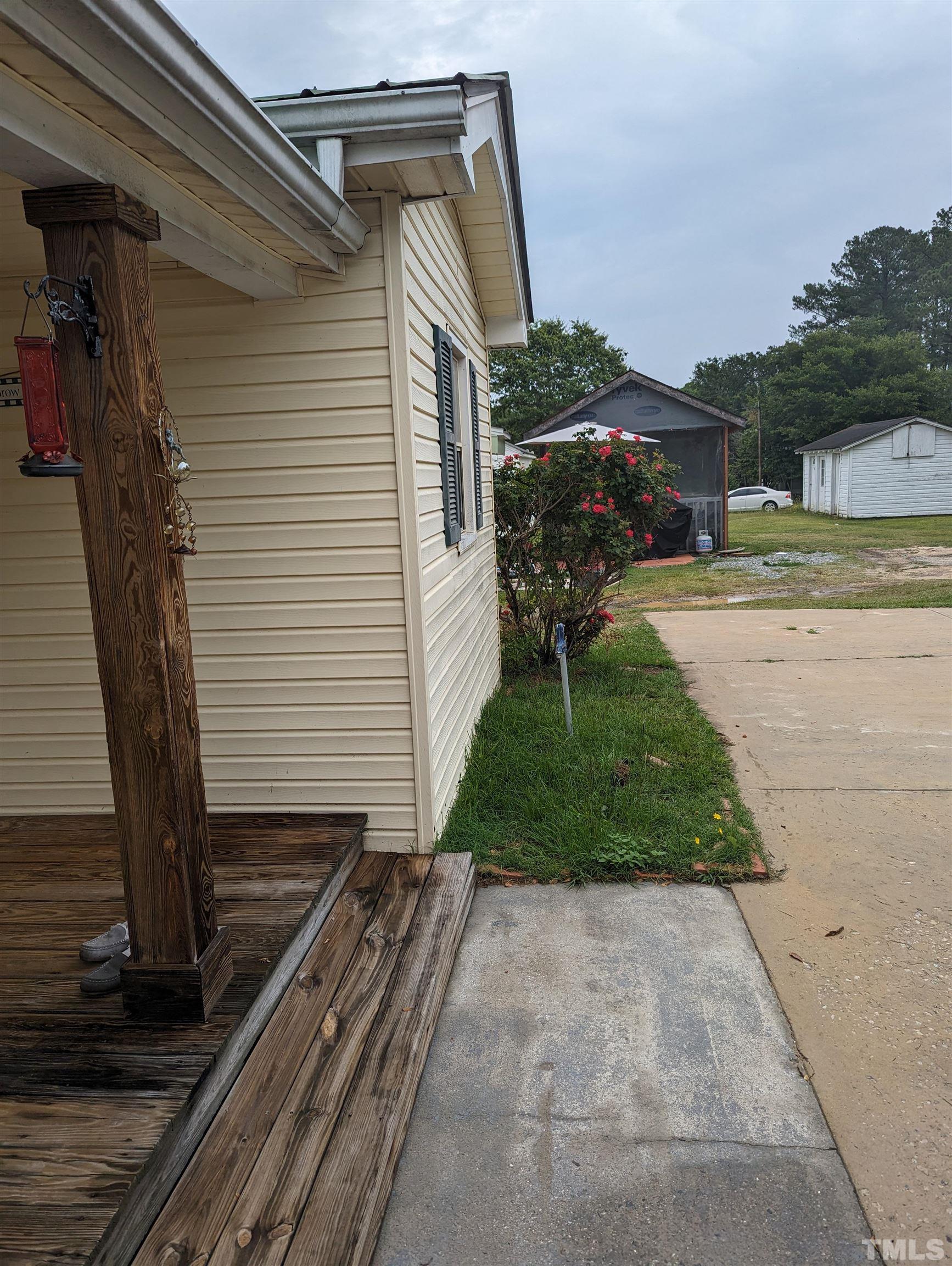 208 East Main Street Coats, NC 27521 - Photo 26 of 27 a front view of a house with garden