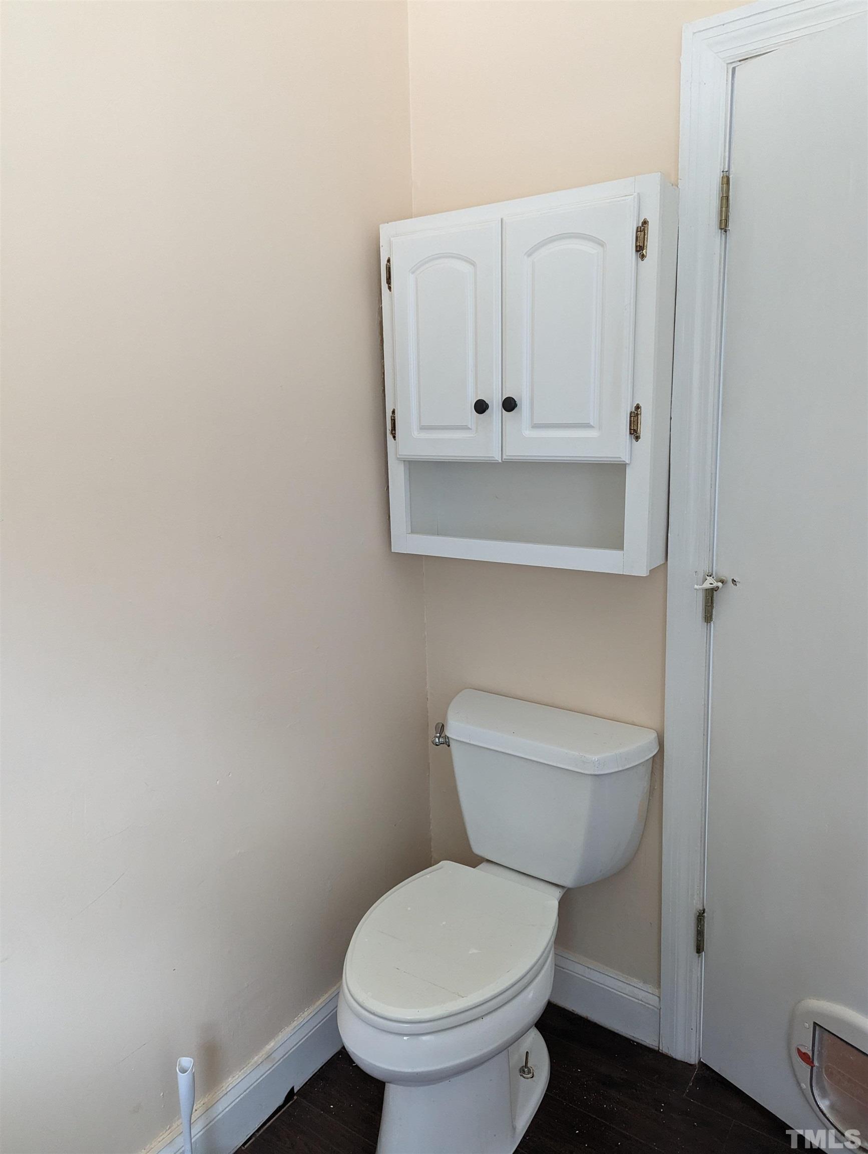 208 East Main Street Coats, NC 27521 - Photo 6 of 27 a white toilet sitting next to a bathroom sink