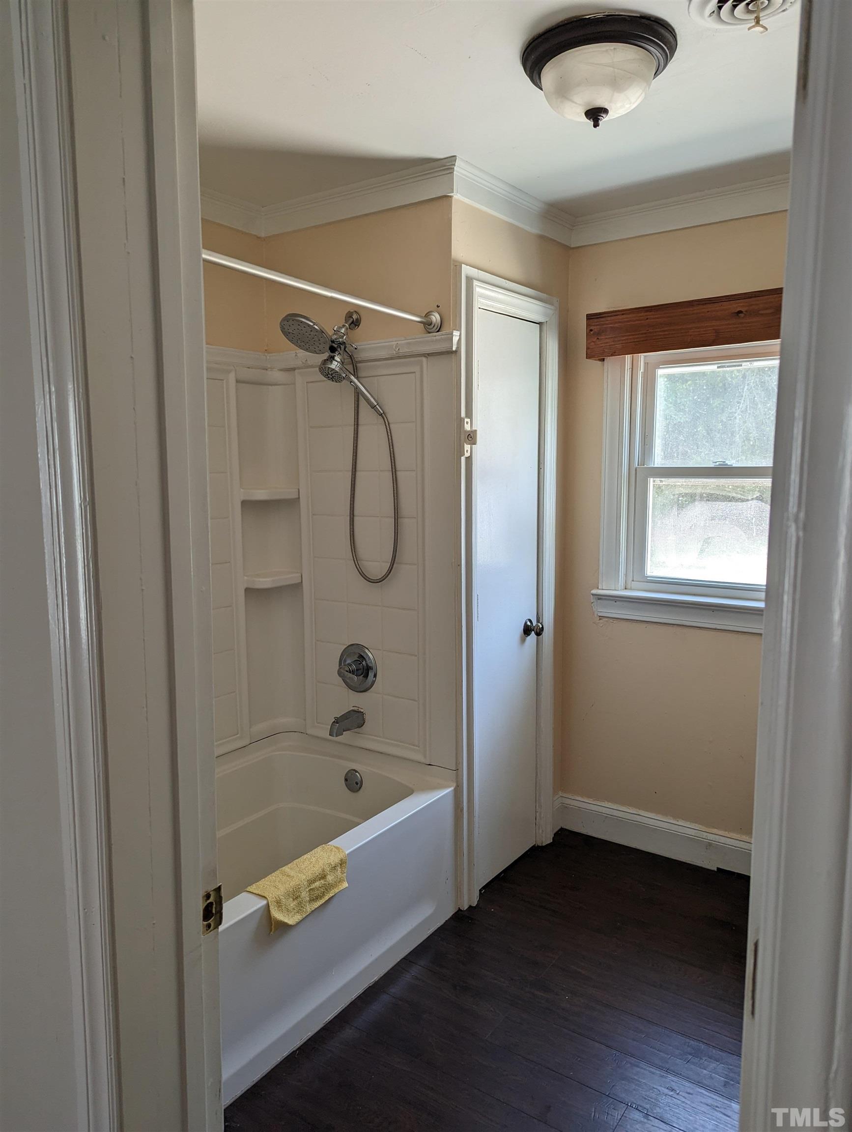 208 East Main Street Coats, NC 27521 - Photo 7 of 27 a bathroom with a bath tub and a shower