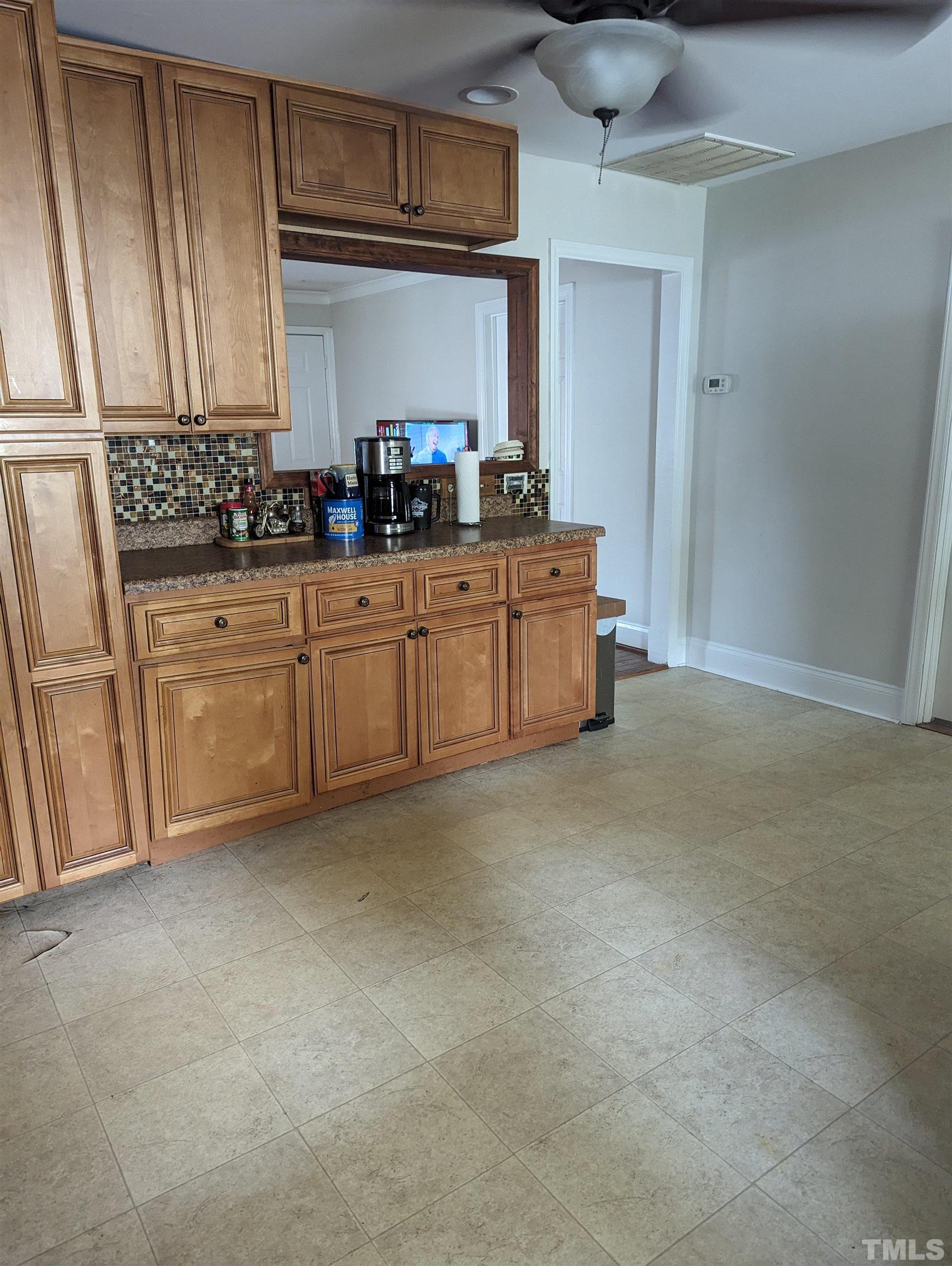 208 East Main Street Coats, NC 27521 - Photo 10 of 27 a kitchen with granite countertop a sink cabinets stainless steel appliances and a window