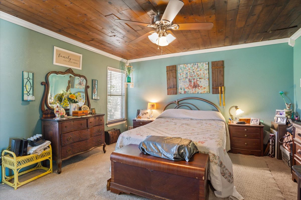 2804 Auction Barn Road Belton, TX 76513 - Photo 13 of 22 Carpeted bedroom featuring wooden ceiling, a ceiling fan, and crown molding