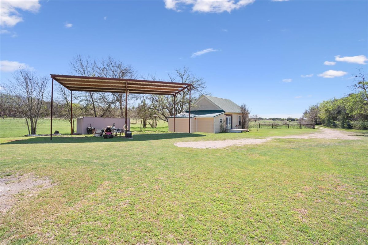 2804 Auction Barn Road Belton, TX 76513 - Photo 4 of 22 View of grassy yard with an outbuilding and a detached carport
