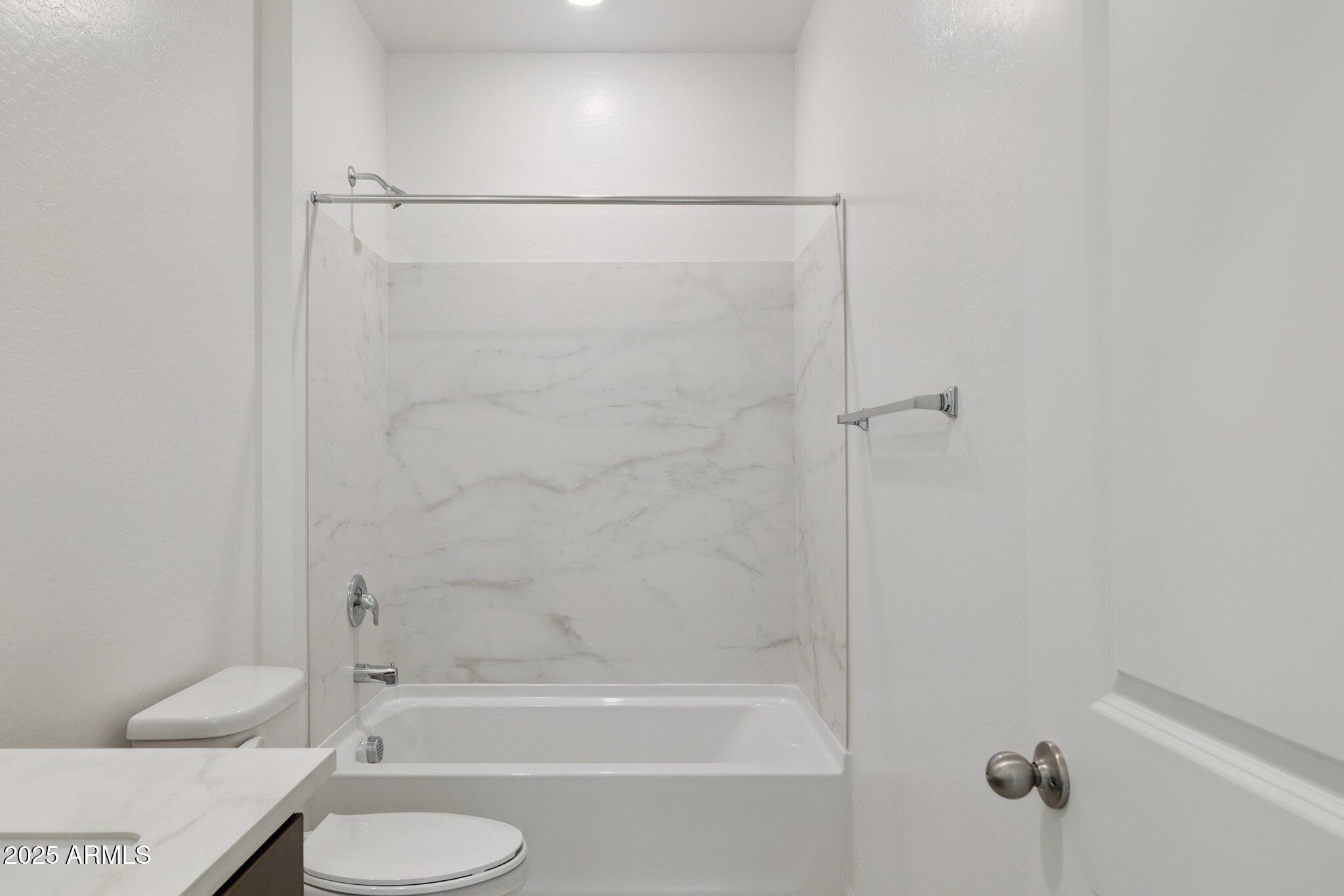 25471 West Fraktur Road Buckeye, AZ 85326 - Photo 13 of 17 a bathroom with a shower and a toilet