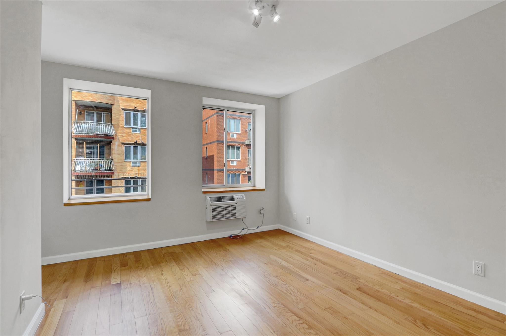 43-17 Union Street, Unit 5A Queens, NY 11355 - Photo 13 of 19 Spare room featuring wood-type flooring and baseboards