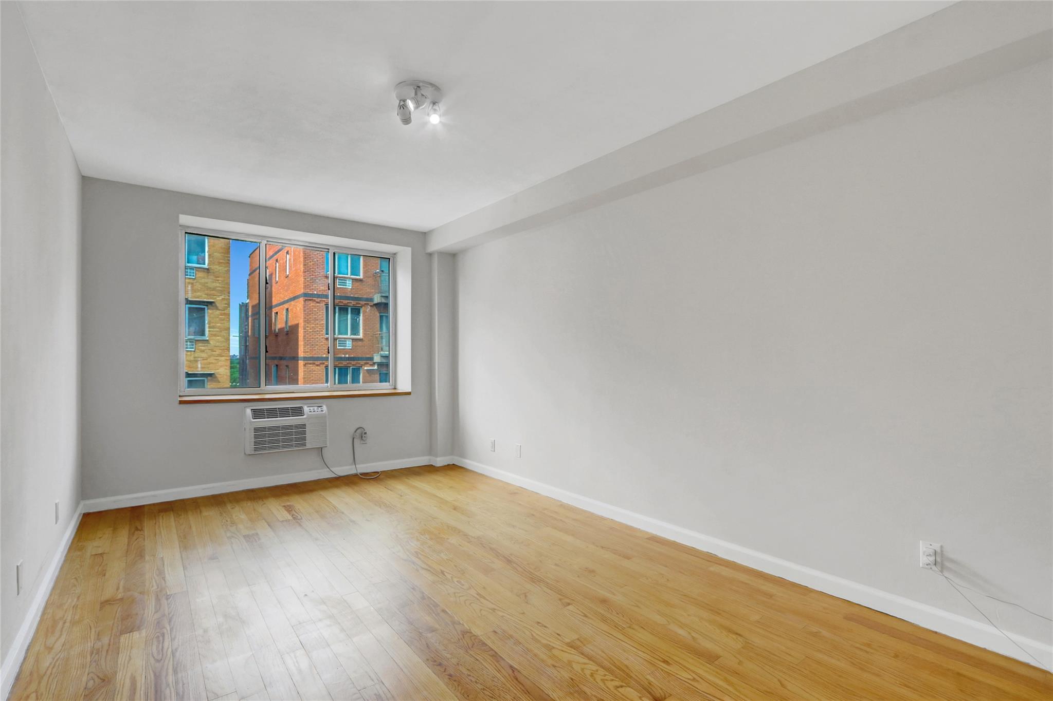 43-17 Union Street, Unit 5A Queens, NY 11355 - Photo 14 of 19 Empty room with wood finished floors and baseboards