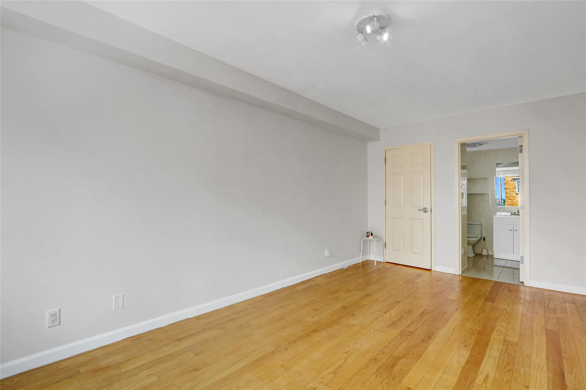 43-17 Union Street, Unit 5A Queens, NY 11355 - Photo 15 of 19 Unfurnished bedroom featuring light wood-type flooring and connected bathroom