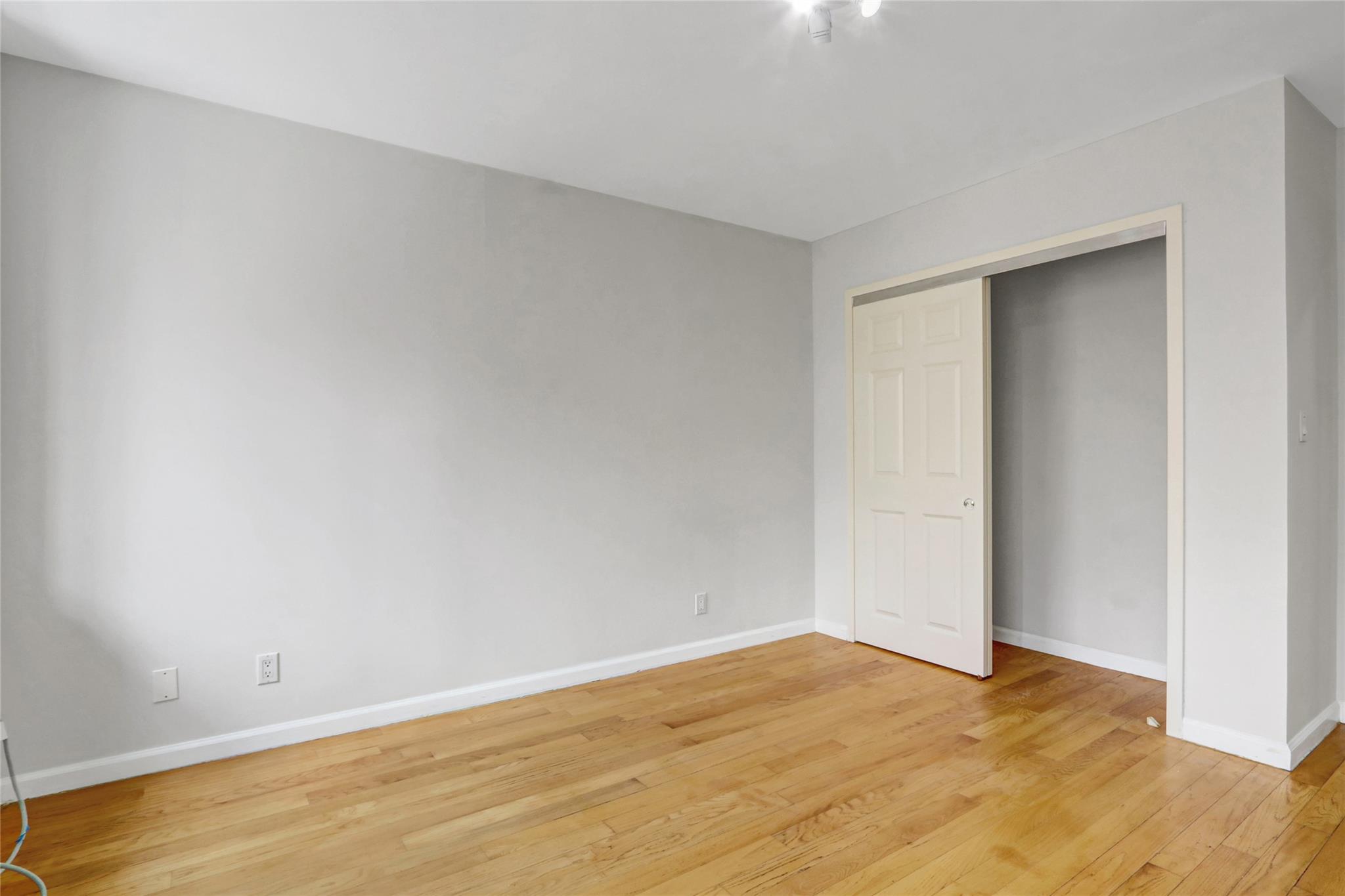 43-17 Union Street, Unit 5A Queens, NY 11355 - Photo 16 of 19 Unfurnished bedroom featuring light wood-type flooring and a closet