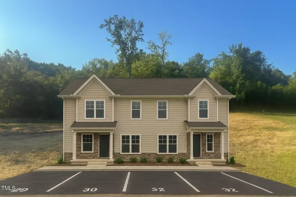 a front view of a house with yard