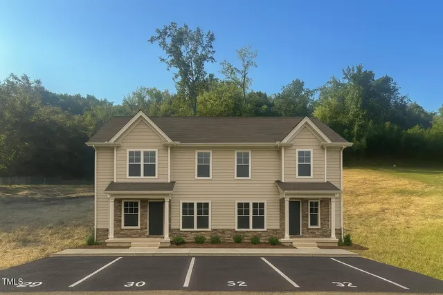a front view of a house with yard