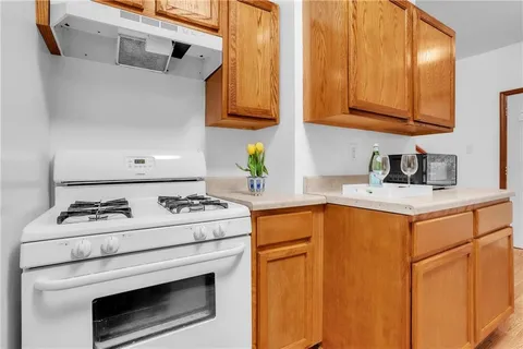 a kitchen with stove and cabinets