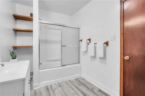 a bathroom with a tub and a window