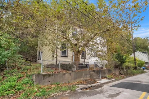 a view of a house with yard and tree s
