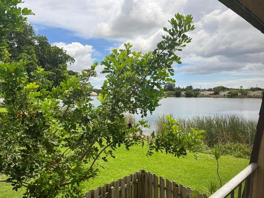 4803 Waterview Circle Palm Springs, FL 33461 - Photo 12 of 22 a view of a lake with a garden