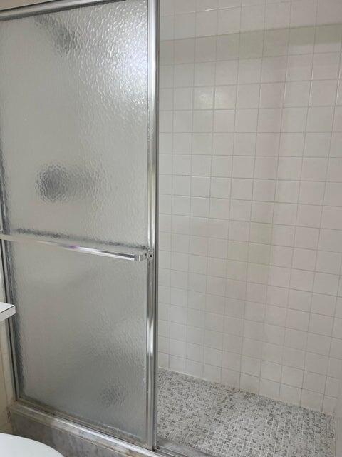 4803 Waterview Circle Palm Springs, FL 33461 - Photo 13 of 22 a bathroom with a glass shower door