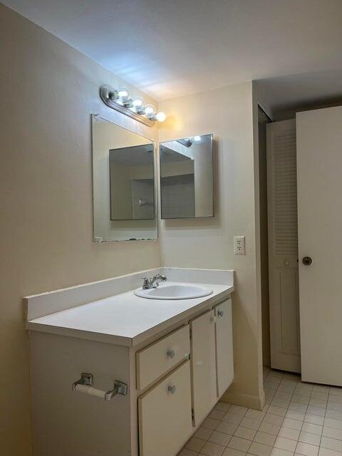 4803 Waterview Circle Palm Springs, FL 33461 - Photo 19 of 22 a bathroom with a sink and a mirror