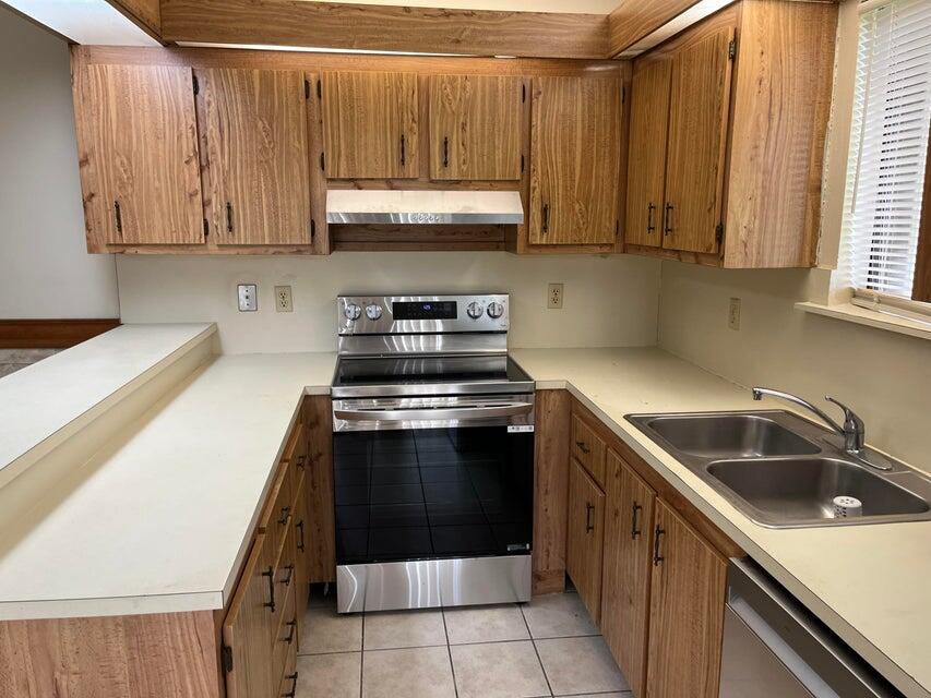 4803 Waterview Circle Palm Springs, FL 33461 - Photo 5 of 22 a kitchen with stainless steel appliances granite countertop a sink and a stove