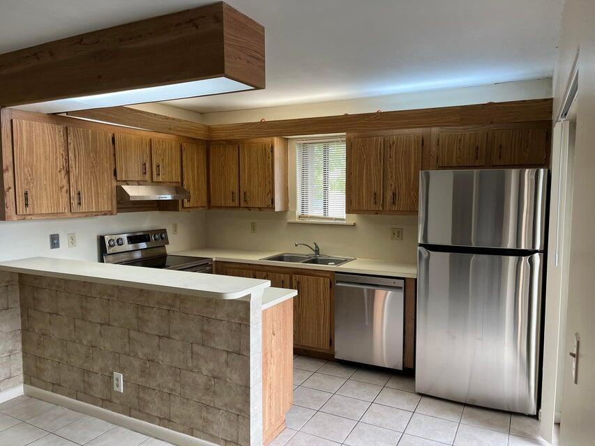 4803 Waterview Circle Palm Springs, FL 33461 - Photo 7 of 22 a kitchen with stainless steel appliances granite countertop a refrigerator a stove and a sink
