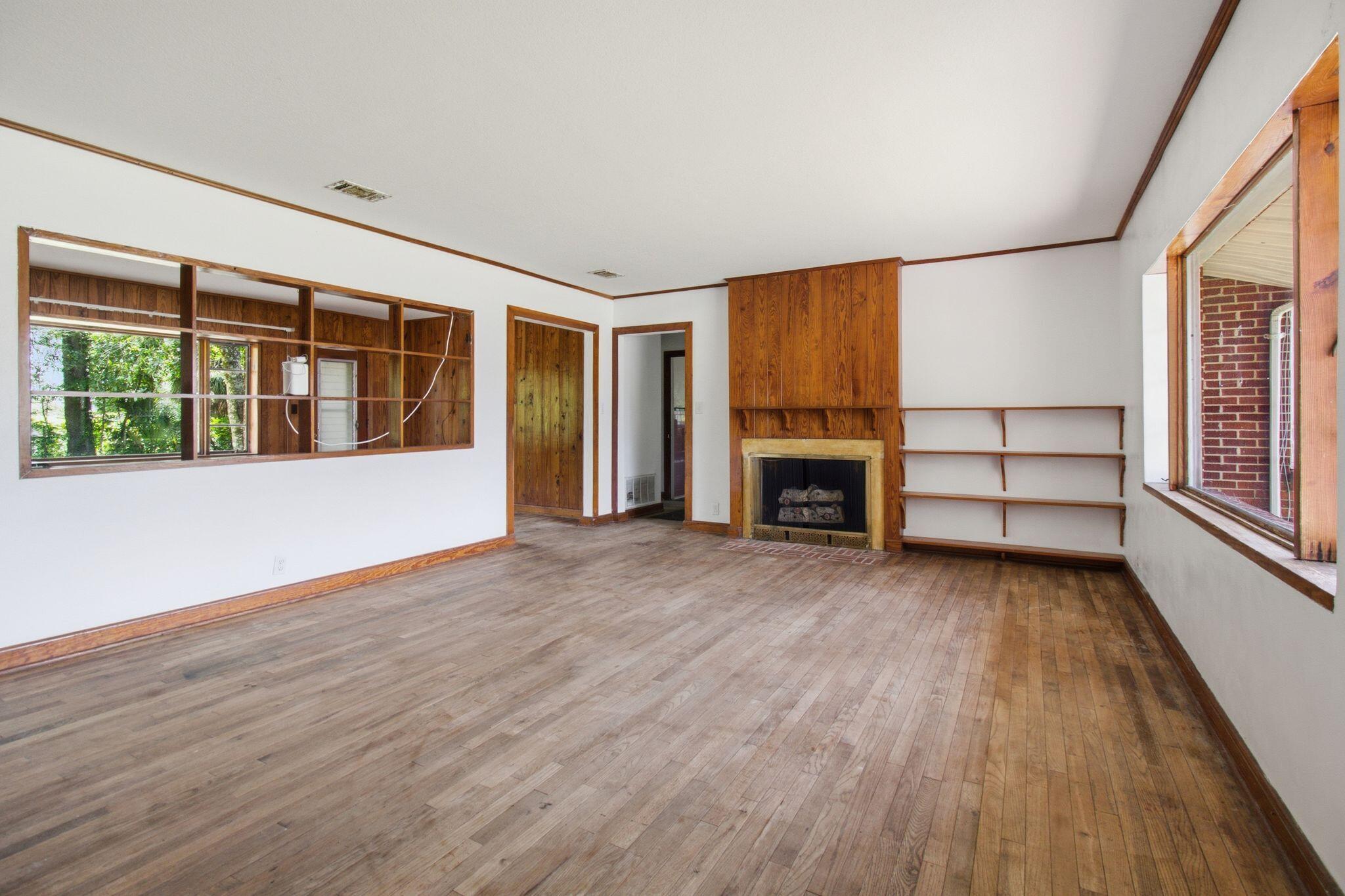 855 North Pearl Street Crestview, FL 32536 - Photo 3 of 31 wooden floor in an empty room with a window