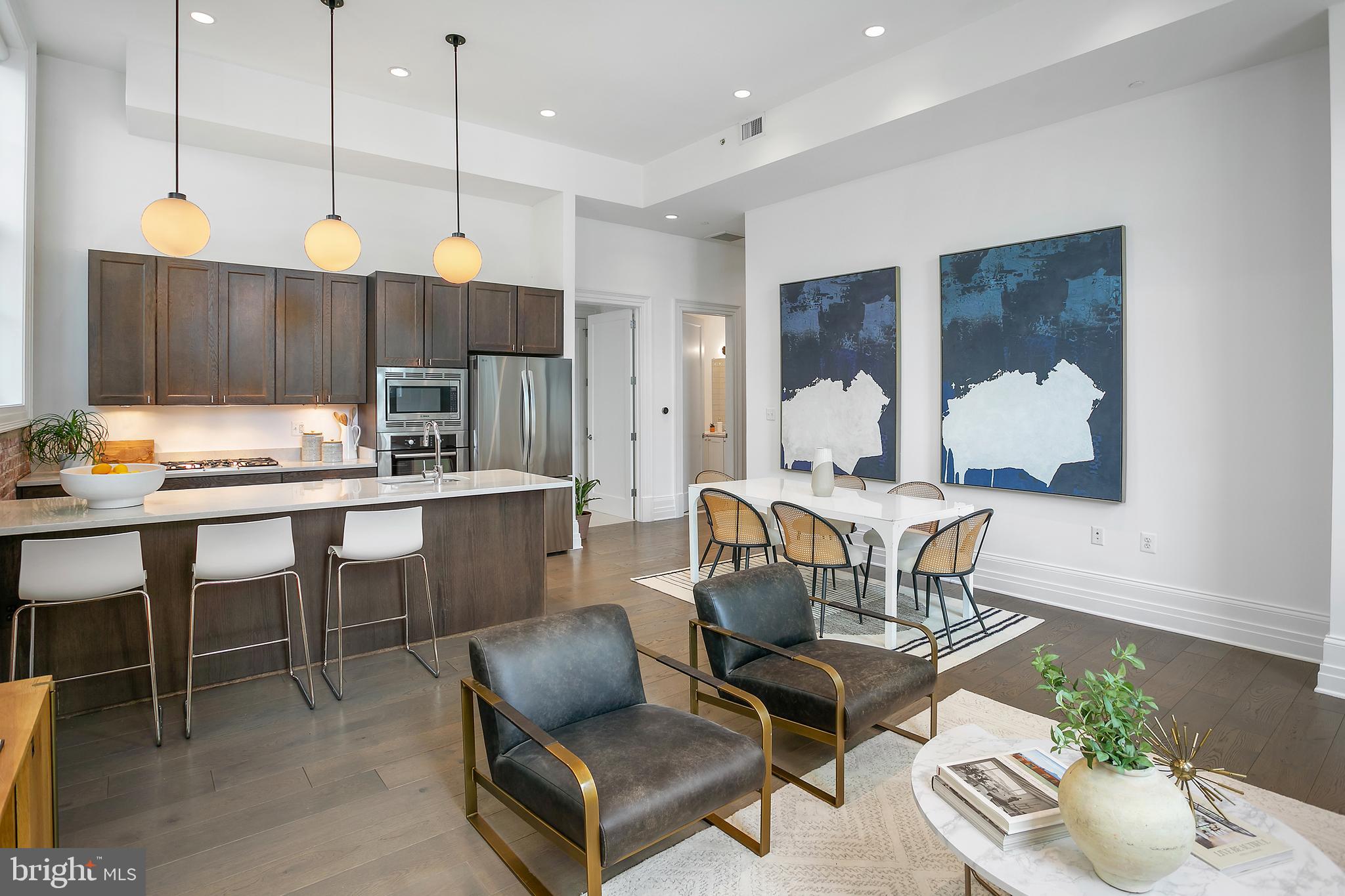 901 D Street Northeast, Unit 102 Washington, DC 20002 - Photo 13 of 40 a room with stainless steel appliances kitchen island granite countertop furniture and a view of living room