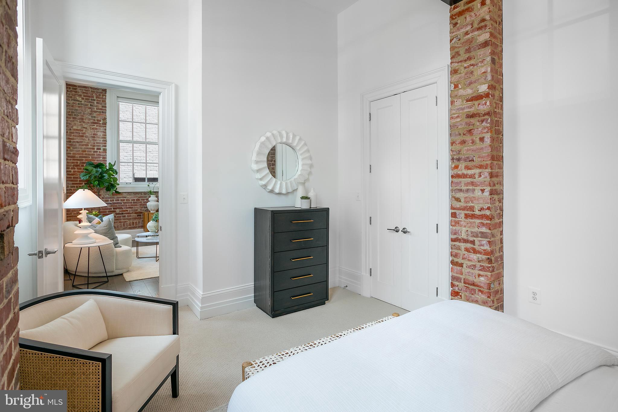 901 D Street Northeast, Unit 102 Washington, DC 20002 - Photo 19 of 40 a bedroom with a bed and a chair