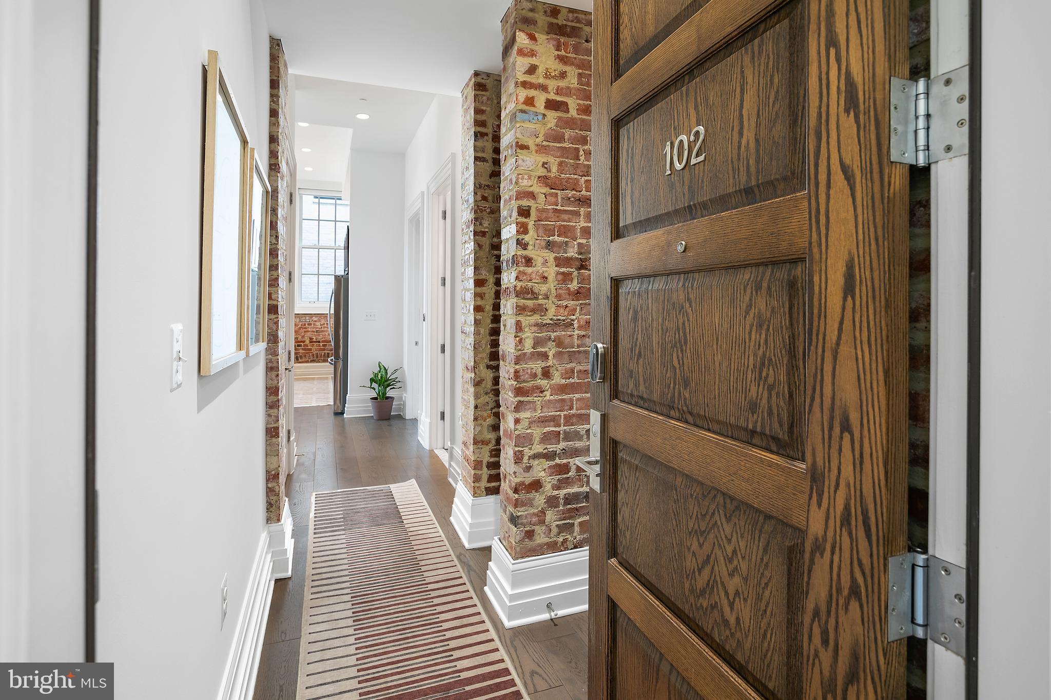 901 D Street Northeast, Unit 102 Washington, DC 20002 - Photo 2 of 40 a view of a hallway with wooden floor and staircase