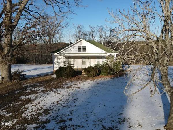 a view of a wooden house with a yard