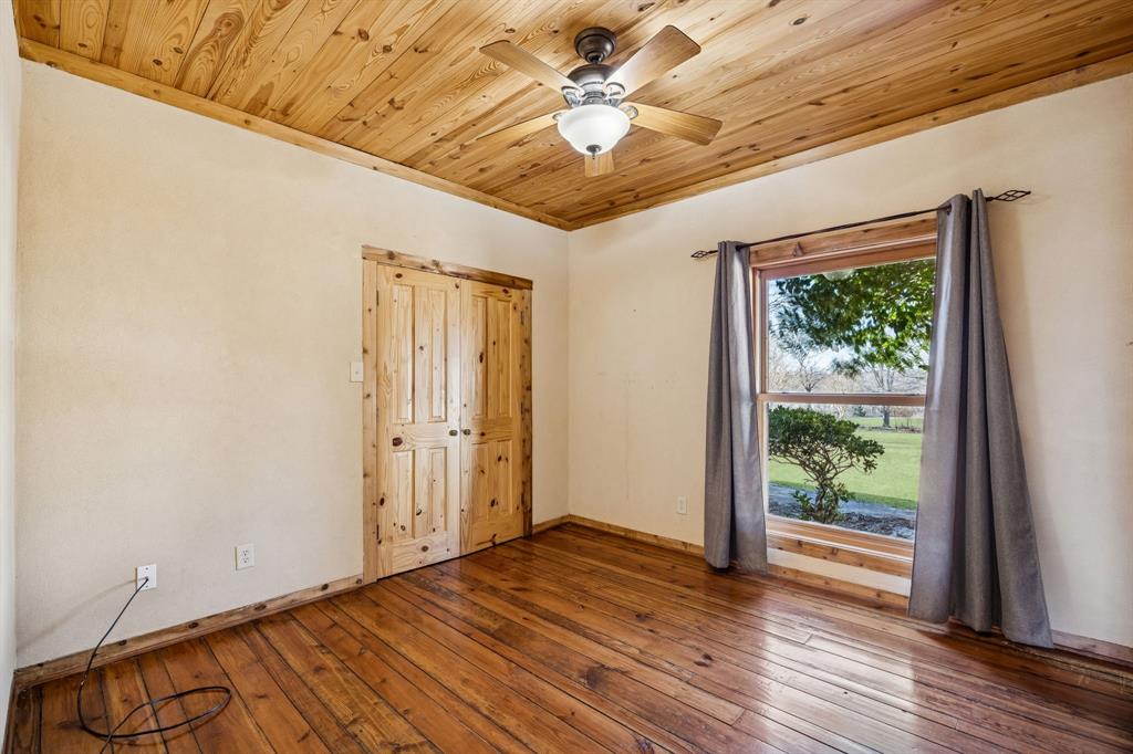 1922 A Bethel-Cannon Road Whitewright, TX 75491 - Photo 18 of 40 Wood-finish flooring and a wood-paneled ceiling with a central ceiling fan