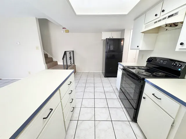 a kitchen with a sink and a stove