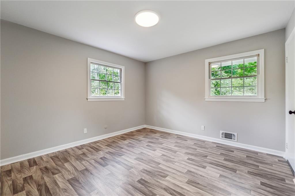 4616 Greensprings Road Atlanta, GA 30337 - Photo 11 of 26 a view of room with window and hardwood floor