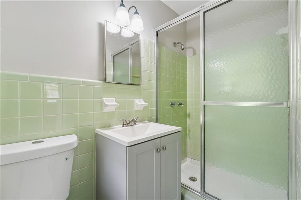 4616 Greensprings Road Atlanta, GA 30337 - Photo 13 of 26 a bathroom with a sink a toilet and shower