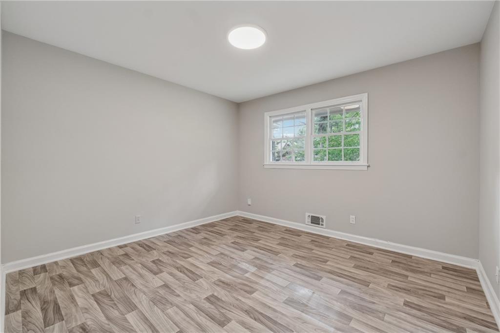 4616 Greensprings Road Atlanta, GA 30337 - Photo 15 of 26 a view of room with window and hardwood floor