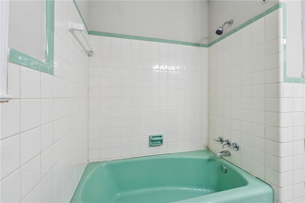 4616 Greensprings Road Atlanta, GA 30337 - Photo 17 of 26 a bathroom with a bathtub and shower