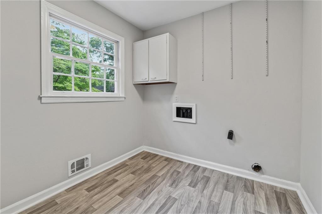 4616 Greensprings Road Atlanta, GA 30337 - Photo 18 of 26 a view of an empty room with a window and wooden floor