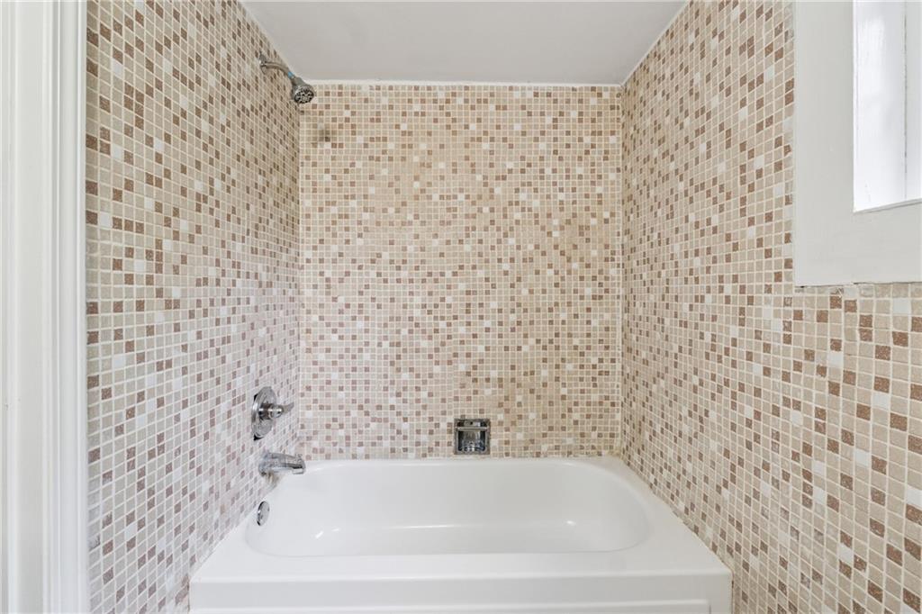 4616 Greensprings Road Atlanta, GA 30337 - Photo 20 of 26 a bathroom with a bathtub and shower