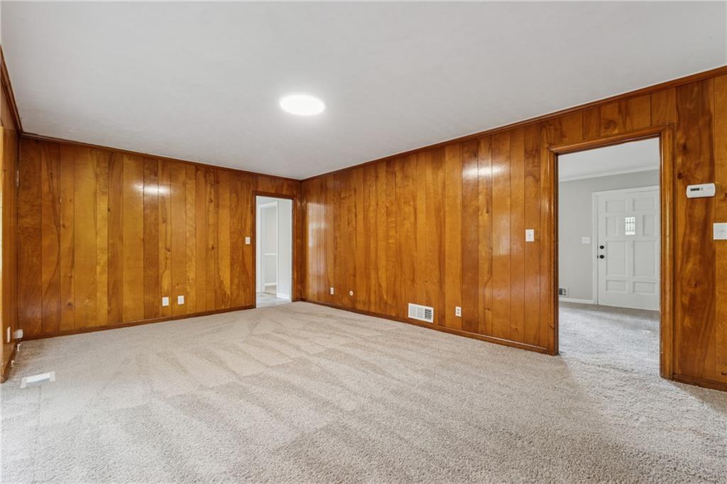 4616 Greensprings Road Atlanta, GA 30337 - Photo 6 of 26 an empty room with a wooden door